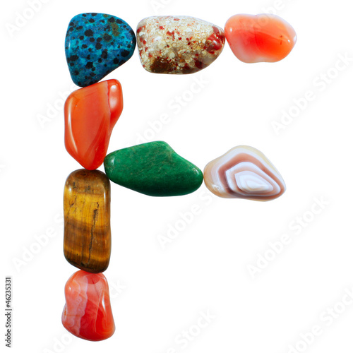 The letter F spelled with semi-precious stones