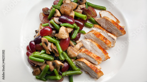 Fresh salad with beans, chicken breast and grapes