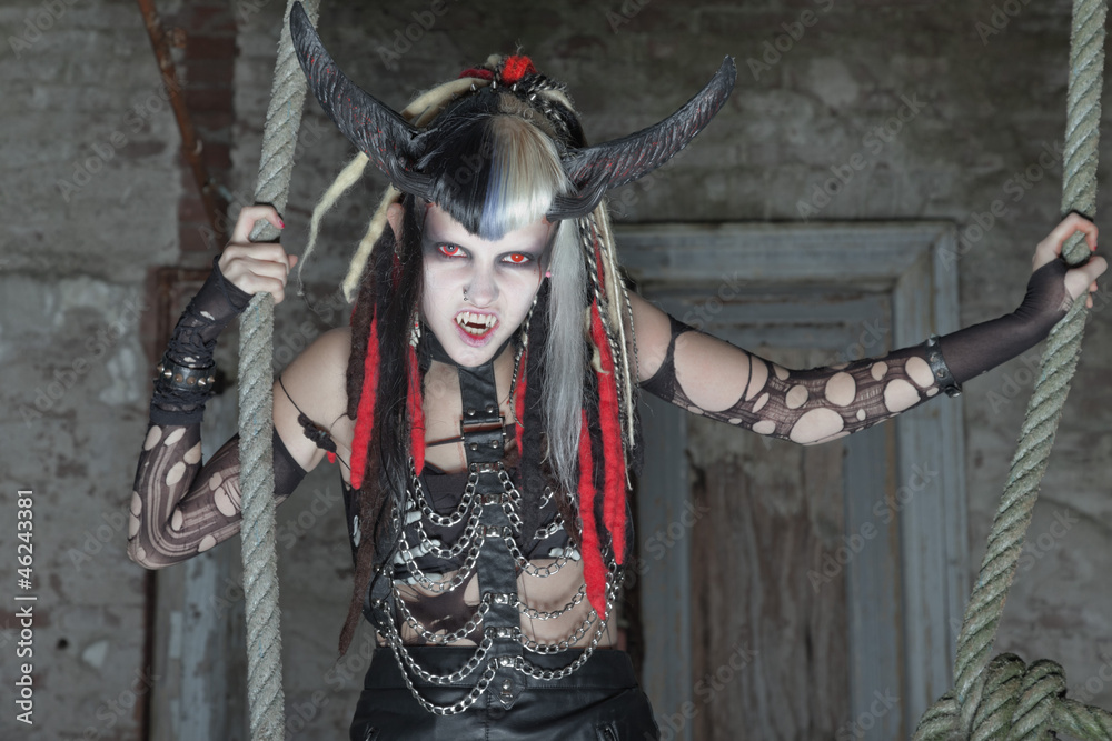 Naklejka premium Scary female demon hanging in ropes.