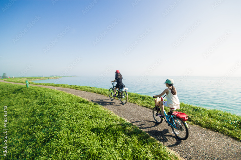 Fototapeta premium Kids riding bikes on summer day