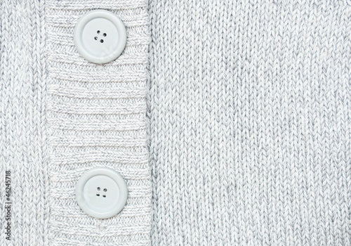 background with Knitted grey sweater with buttons Knitted woole