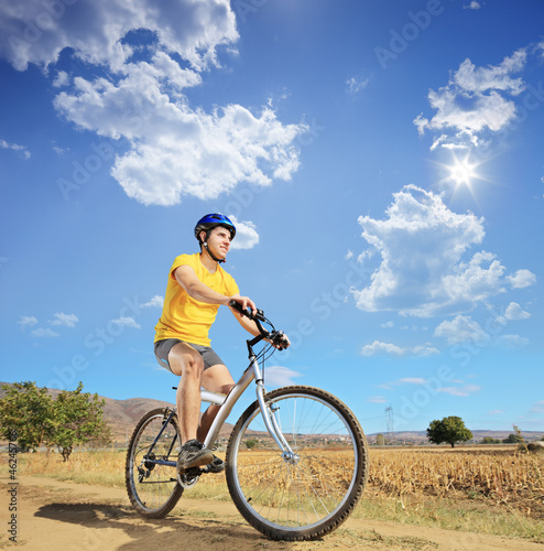 A young male riding a bike