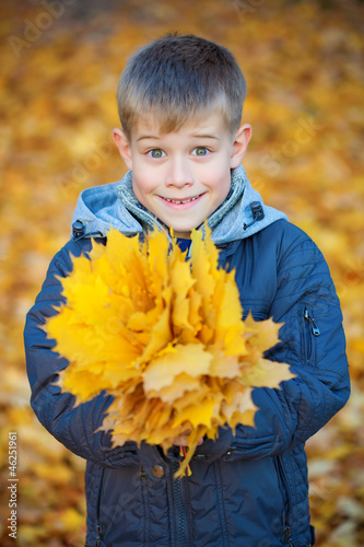 happy kid on a background of  autumn leafs