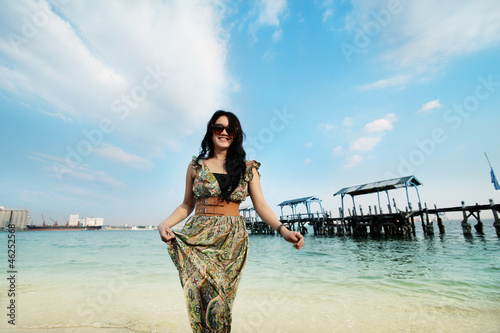 black long hair young 20s beautiful asian woman in beach vacation and relaxing posing with wooden pier at background photo