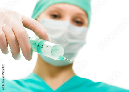 Surgeon woman with syringe making injection,