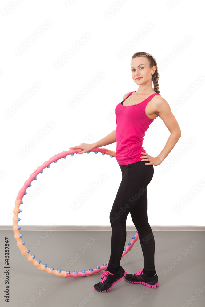 Athletic young woman with hula hoop