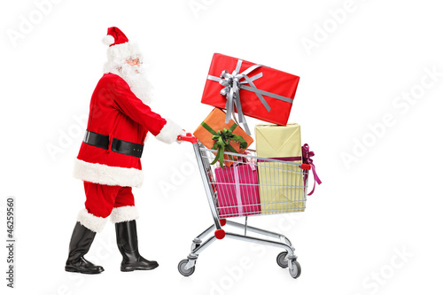 Santa Claus standing next to a shopping cart full of gifts © Ljupco Smokovski