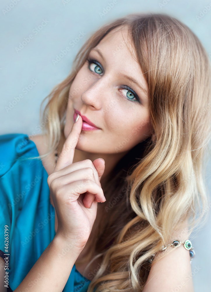 Portrait of a beautiful young blonde on the background of the ro Portrait of a beautiful young blonde on the background of the ro