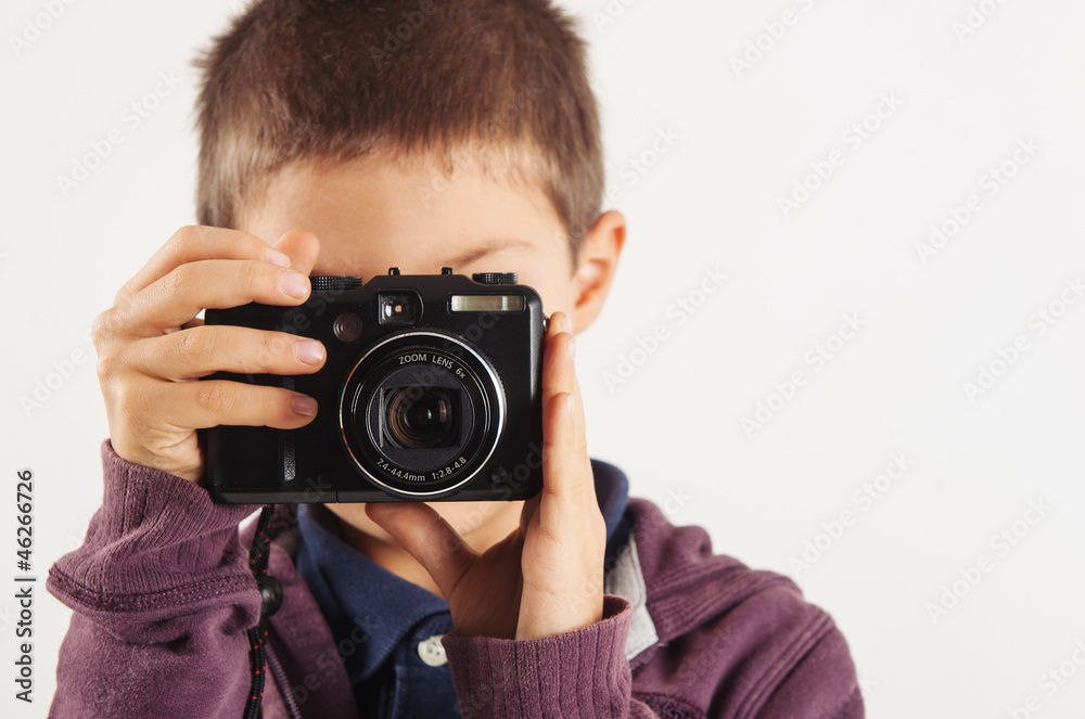 Child with digital compact camera, isolated on white background. Child with digital compact camera, isolated on white background.