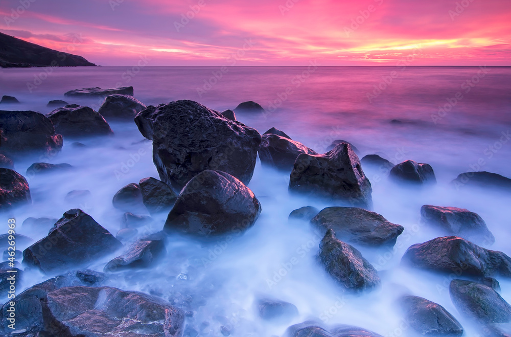 Stones in the sea at the sunset - obrazy, fototapety, plakaty 