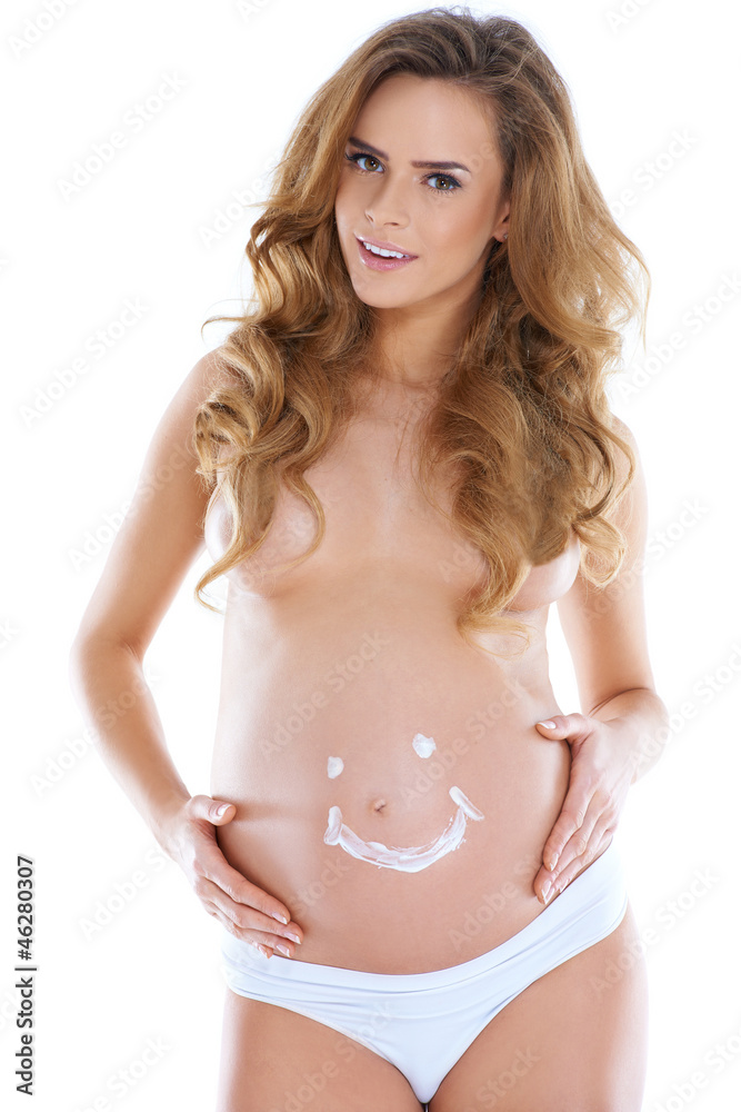 Fototapeta premium Young pregnant woman with smile shape pained