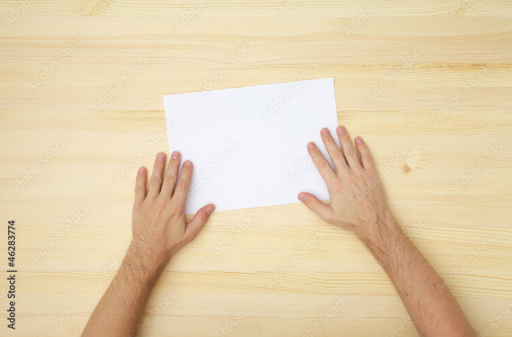 male's hand holds a blank paper male's hand holds a blank paper