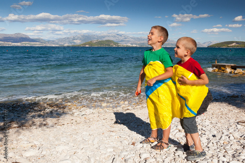 Two happy boys on a beach.