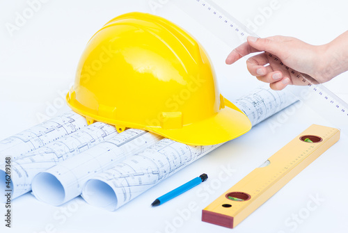 architect measuring tools and construction helmet