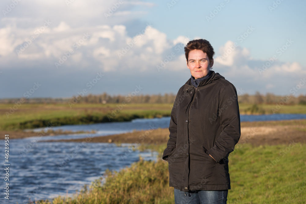 Woman in a beautiful wetland landscape in the Netherlands Woman in a beautiful wetland landscape in the Netherlands