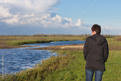 Woman in a beautiful wetland landscape in the Netherlands © Kruwt