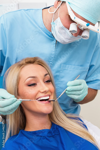 Dentist examines teeth of the patient on the dentist s chair