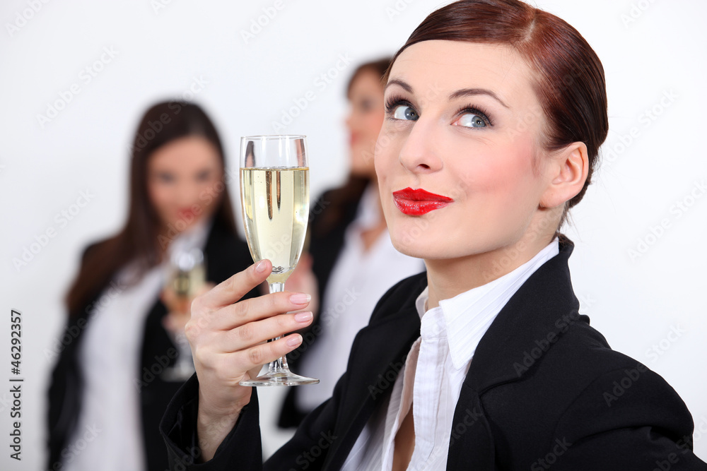 Females coworkers drinking champagne. Females coworkers drinking champagne.