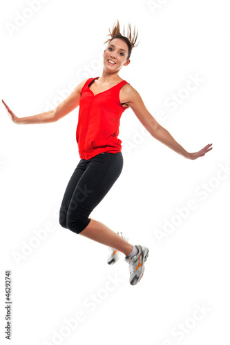 Young fit woman jumping in the air