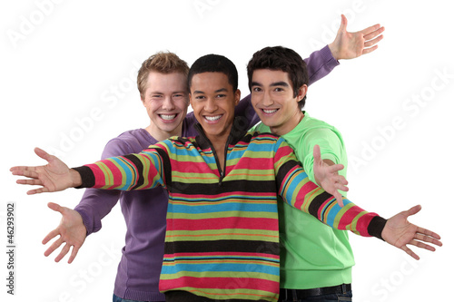 Three male friends making welcome gesture photo