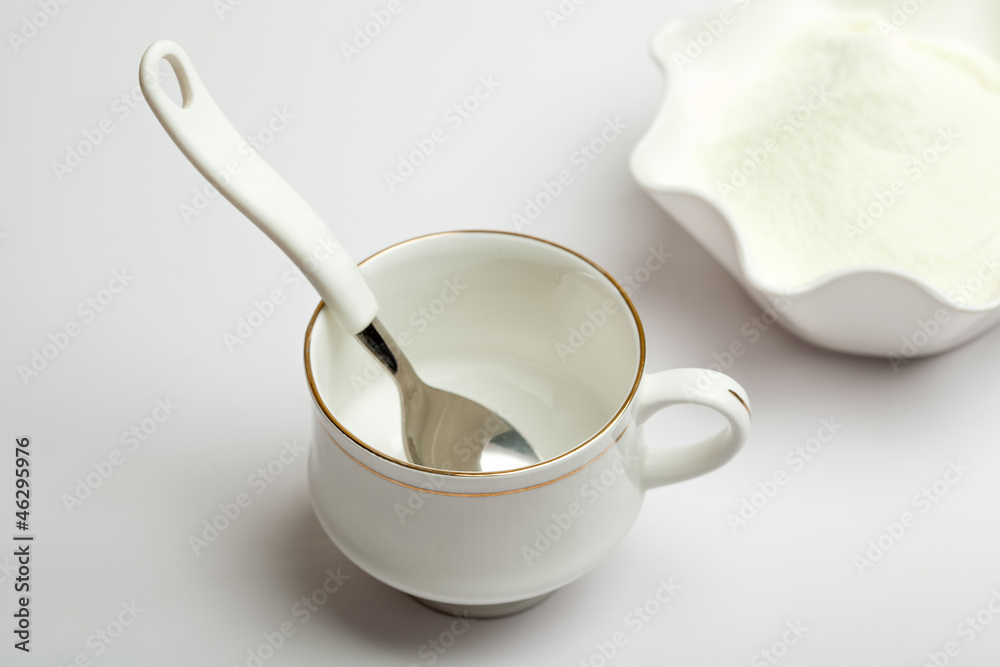 White cup, spoon and milk powder White cup, spoon and milk powder