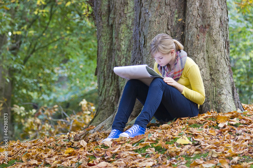 Lovely girl drawing in the park photo