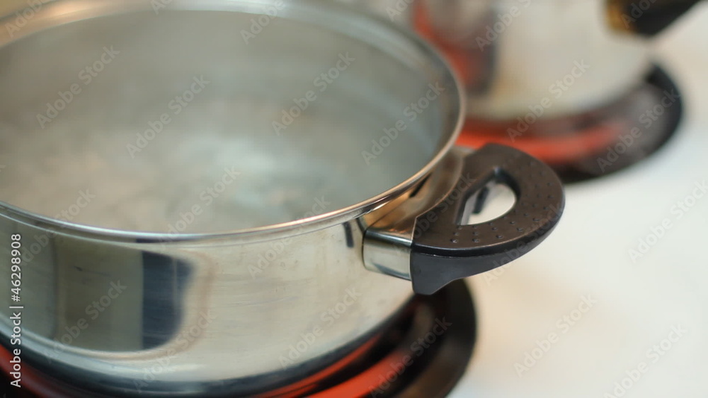 Pot full of boiling water on the electric stove. Pot full of boiling water on the electric stove.