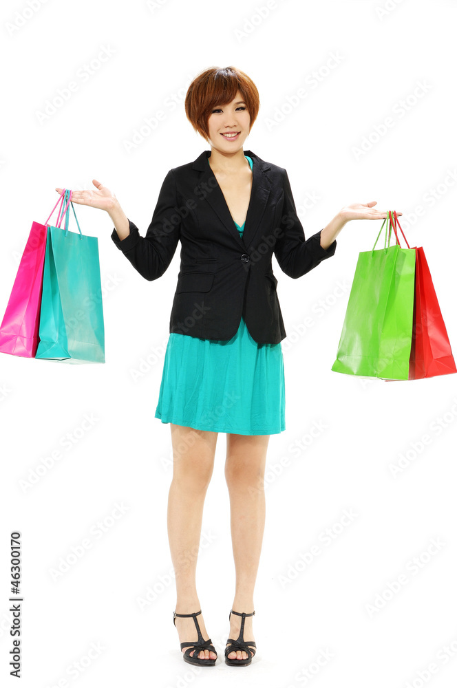 Cheerful young woman r holding shopping bags