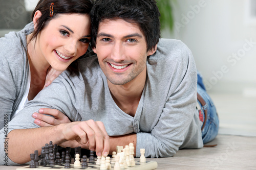 Attractive couple playing chess