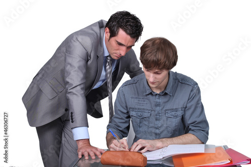Teacher helping a student with his studies