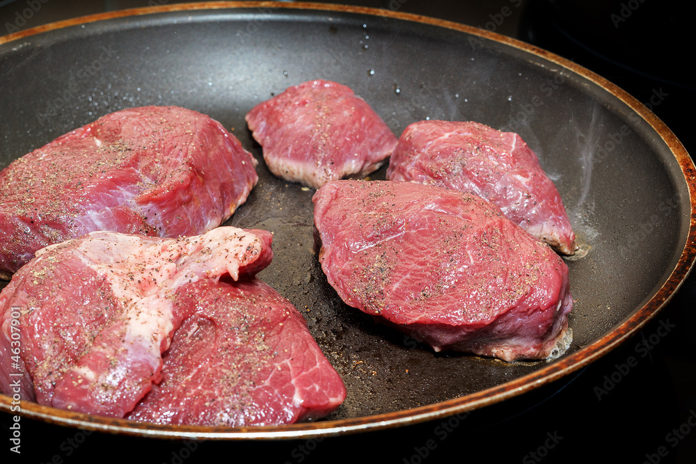 beef meat on pan with pepper and sea salt beef meat on pan with pepper and sea salt