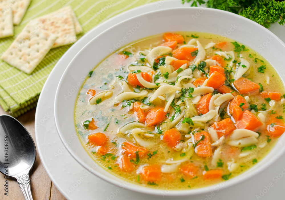 Homemade chicken noodle soup with crackers. Homemade chicken noodle soup with crackers.