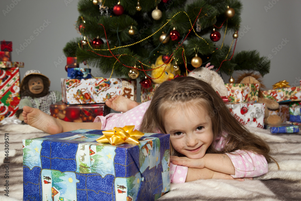 The girl with a gift under the Christmas tree The girl with a gift under the Christmas tree