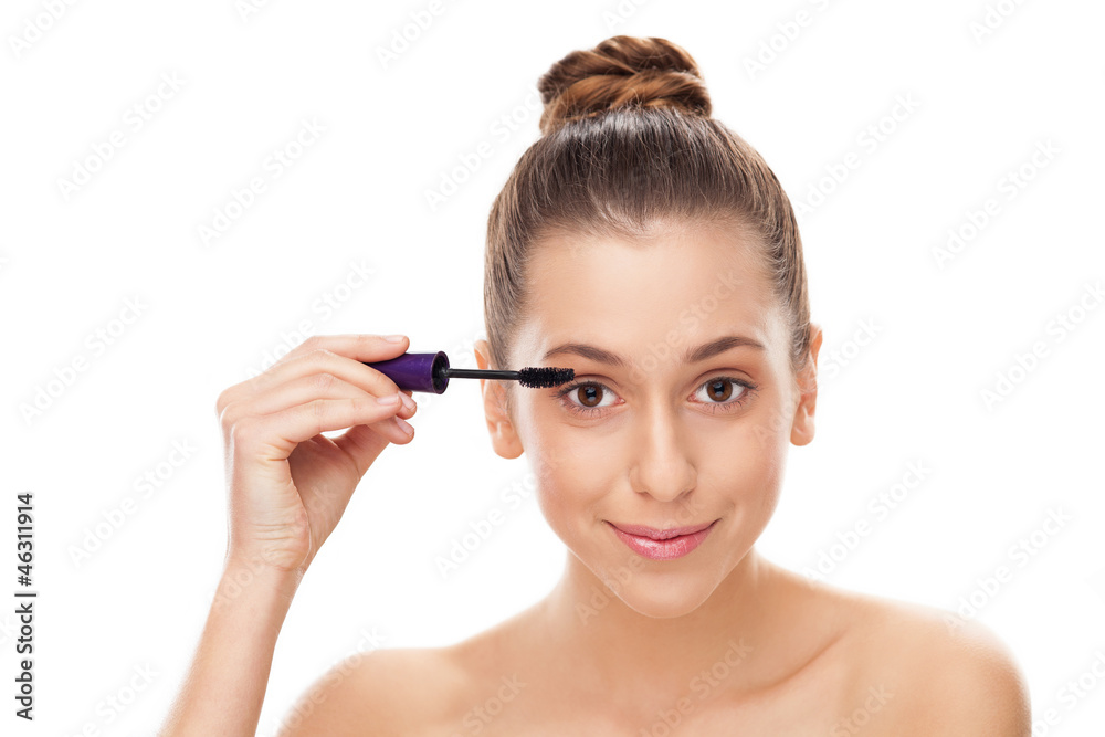 Woman applying mascara