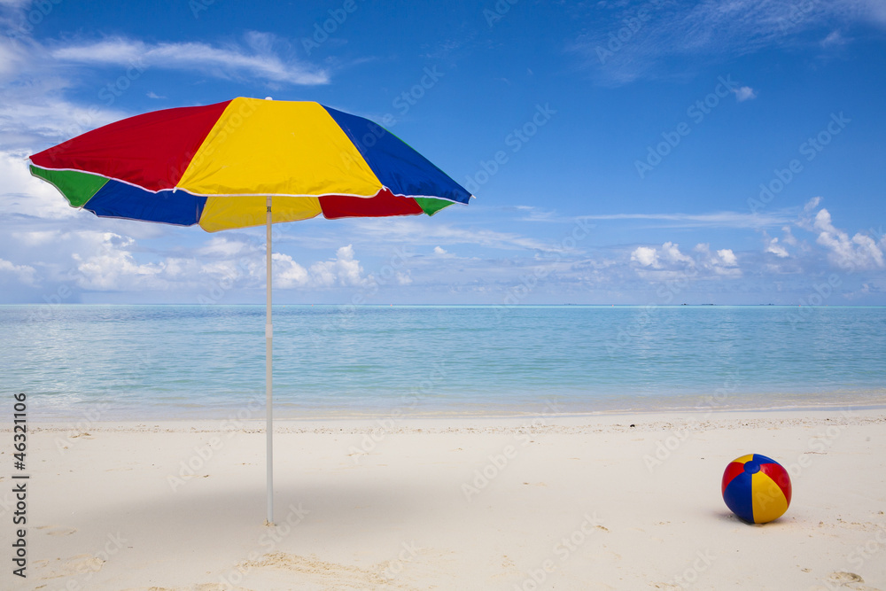 colorful sunshade and ball at the beach