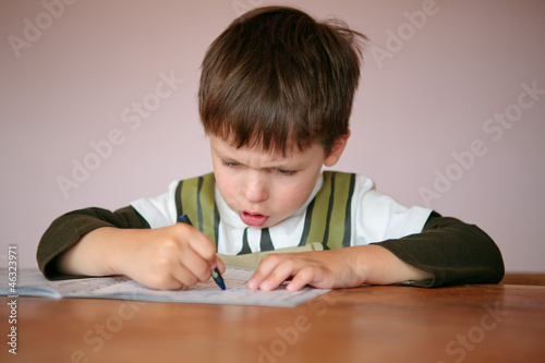 Young boy doing his homework at home