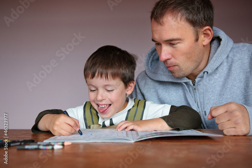 Father helping son doing homework