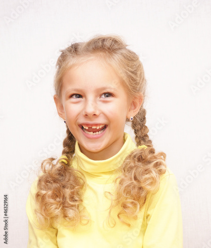 Laughing girl with fallen milk teeth