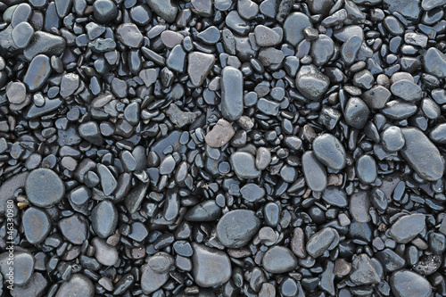 Background of wet black pebbles photo