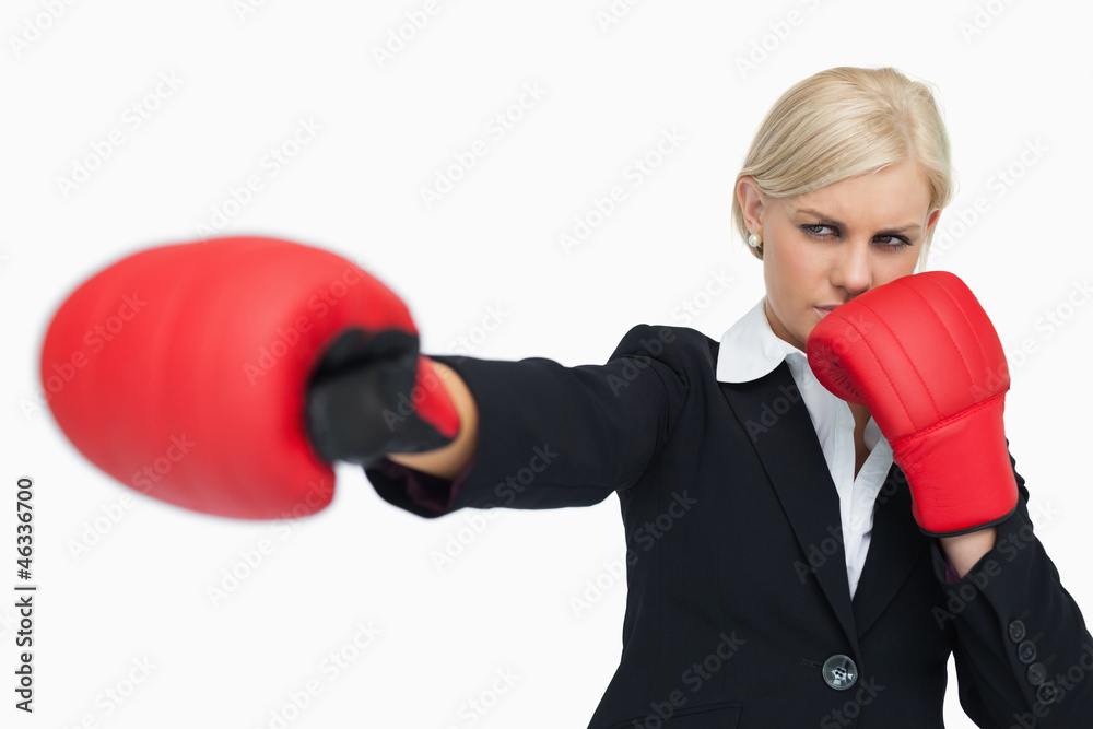 Blonde businesswoman with red gloves fighting Blonde businesswoman with red gloves fighting