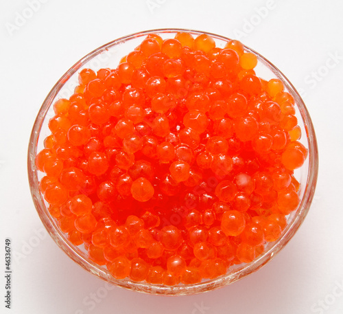 Red caviar in the bowl isolated