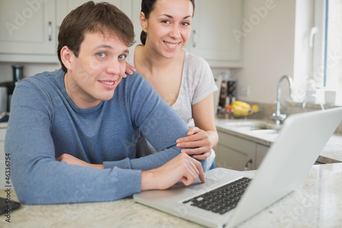 Cute couple using laptop