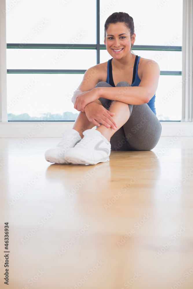 Woman sitting in fitness studio