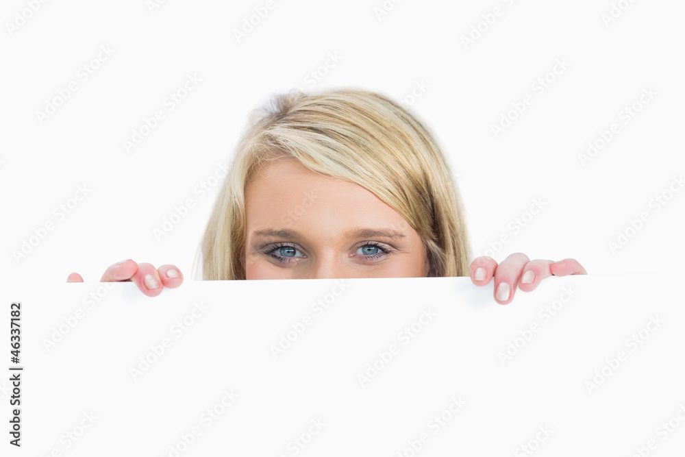 Woman hiding behind a notice