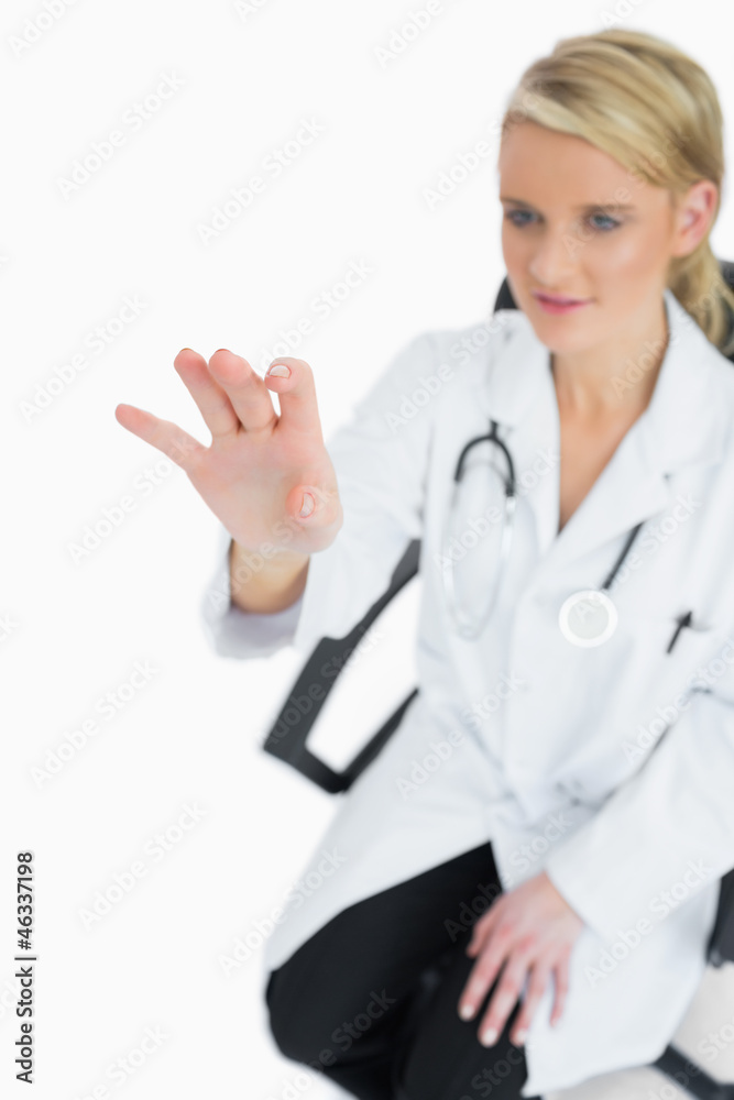 Sitting doctor touching something