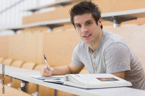 Student sitting at the desk smiling