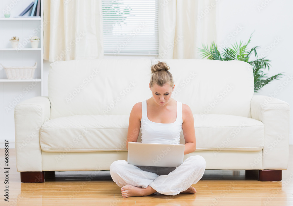 Blonde sitting on the floor with laptop Blonde sitting on the floor with laptop