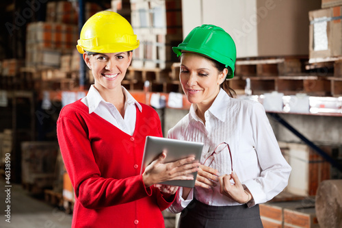 Female Supervisor With Colleague At Warehouse
