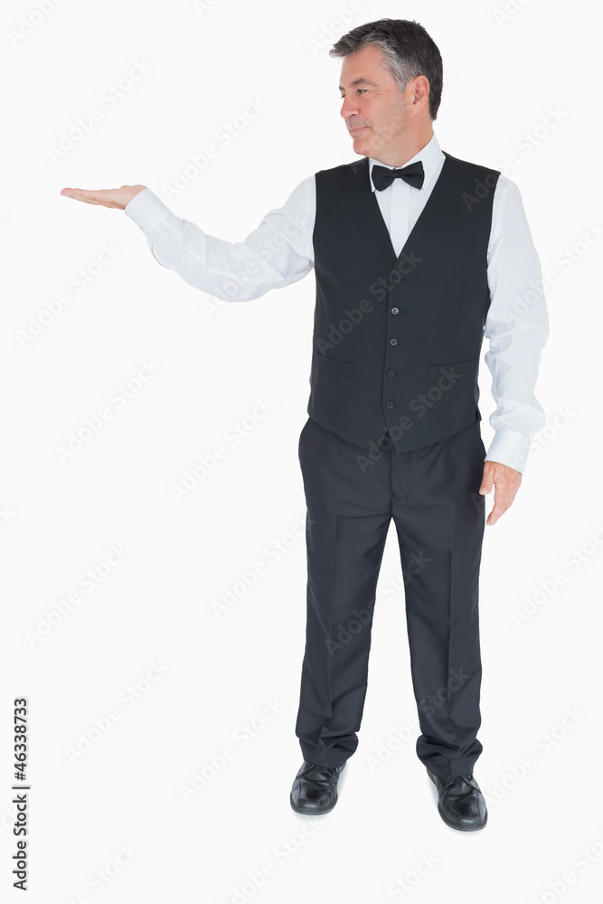 Waiter holding hand out to the left Waiter holding hand out to the left