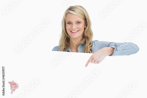 Woman holding a poster and pointing on it